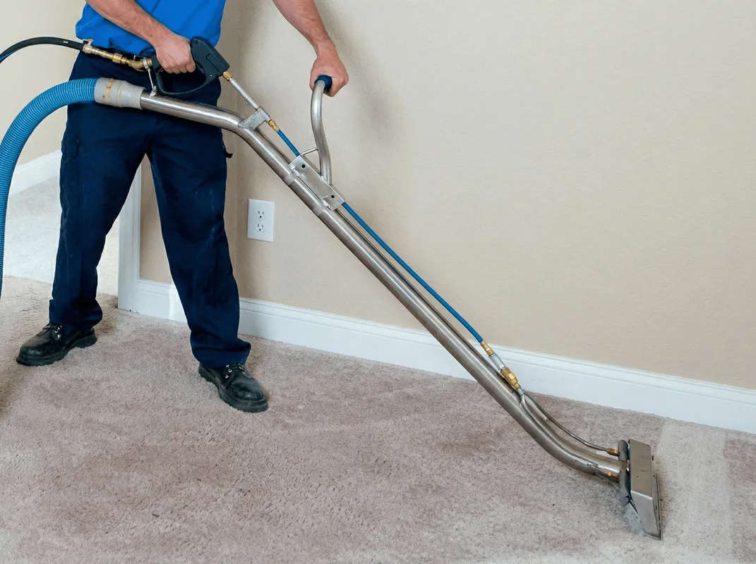 Professional operating a liquid removal machine on a carpeted floor in Clearwater, FL
